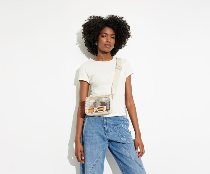 The clear Stadium Bag worn crossbody on female talent, letting her be hands free, and showing how clear the bag so it meets stadium and venue regulations
//
Model is 5'9"