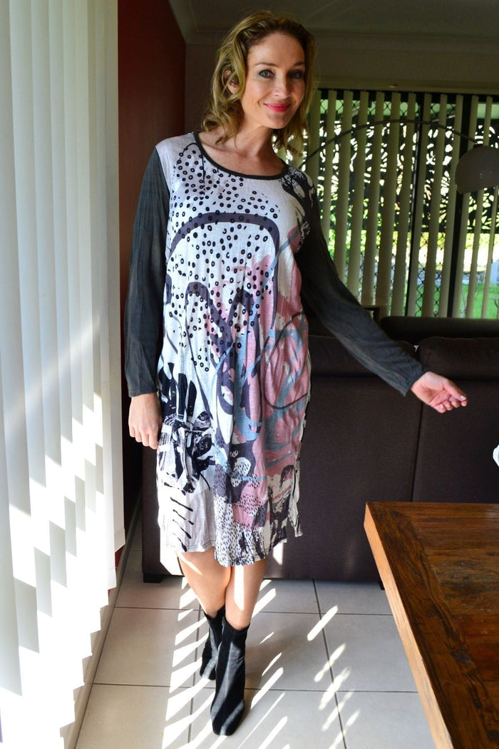 Sweet Caroline crinkle tunic dress by Cafe Latte, featuring a relaxed fit with textured fabric and long sleeves, displayed on a hanger.