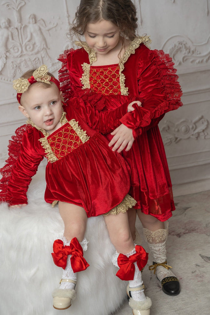 Victoria red hair sash worn by a young girl, featuring an ivory lace bow and classic holiday styling